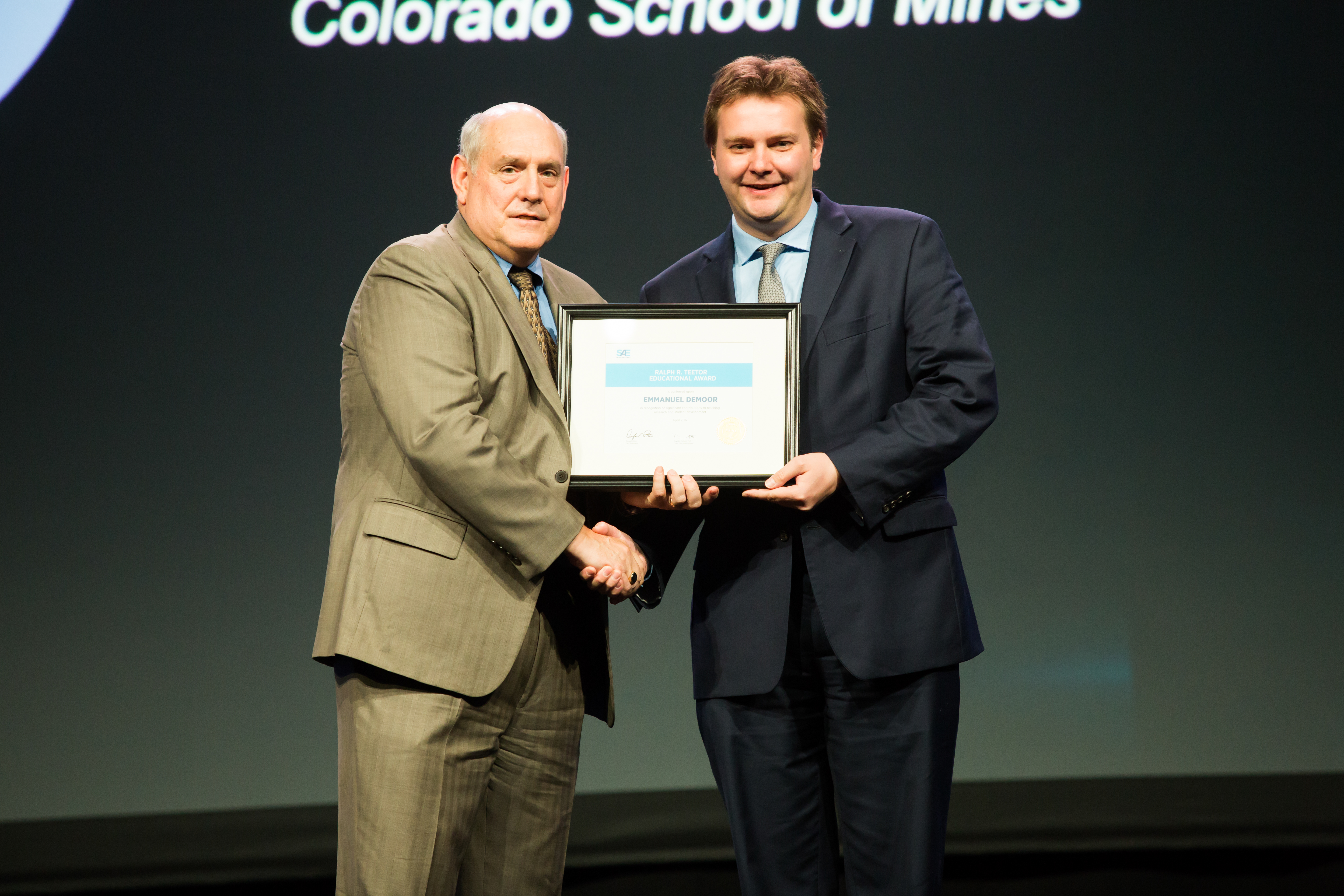 Emmanuel De Moor, right, receives the Teetor Award during the SAE World Congress.